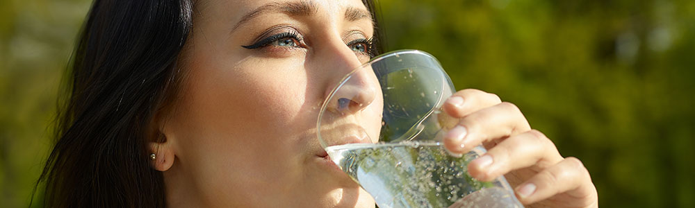 Woman with glass of sparkling water