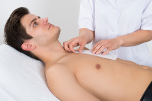 Beauty Therapist Waxing Man's Chest