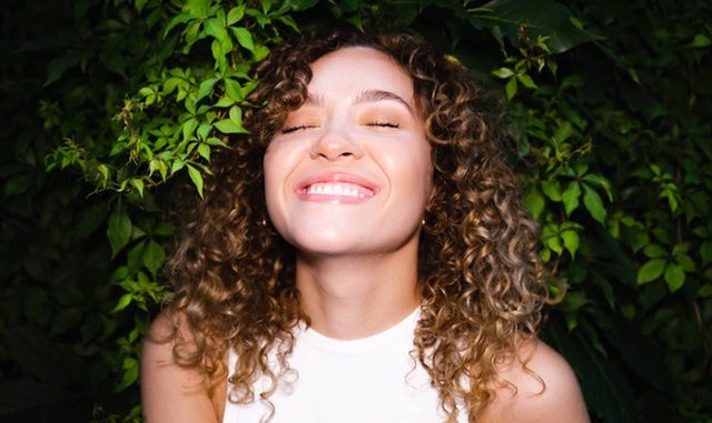 smiling-woman-with-curly-hair-2723116