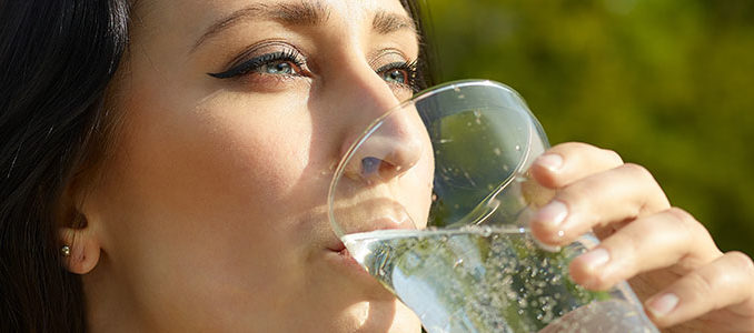 Woman with glass of sparkling water